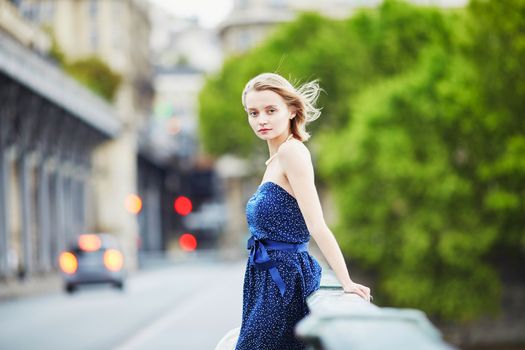 Beautiful young elegant French woman in Paris outdoors