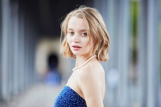 Beautiful young elegant French woman in Paris outdoors