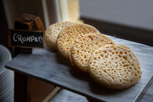Hot toasted English crumpets arranged in a line