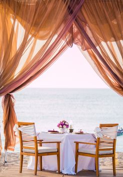 Romantic dinner table set on the beach