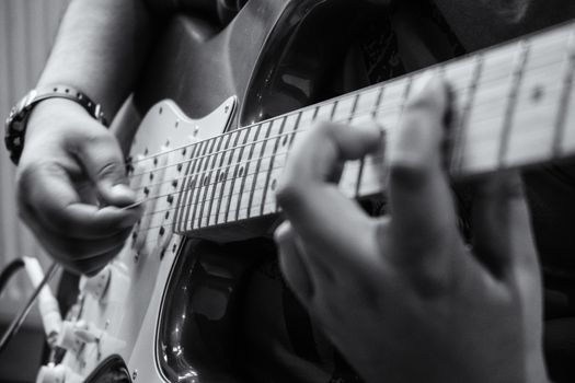 A young child playing an electric guitar