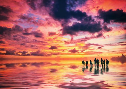 Silhouettes of people at sunset on the beach of Kuta Bali Indonesia