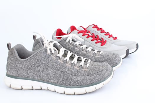 2 gray sneakers pair side by side. On a white background