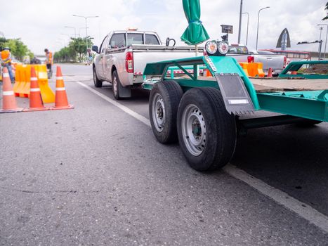 transporting small  cargo trailer for a car strapped on the road