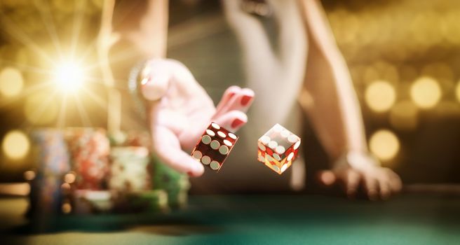 Woman gambling at the craps table at the casino - Selective focus