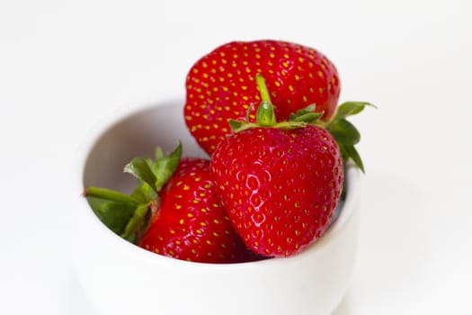 A bowl of strawberries on a white background