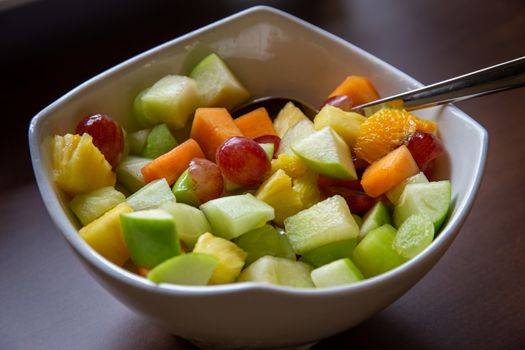 Large white bowl of healthy fresh fruit salad