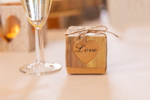 Love concept.  Champagne glass and box with love text in a wedding setting