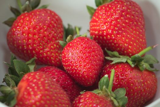 A pile of strawberries in a bowl