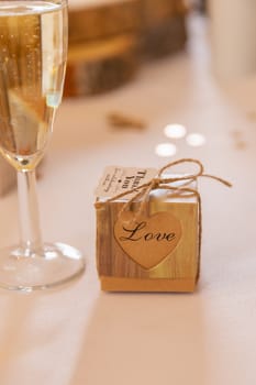 Love concept.  Champagne glass and box with love text in a wedding setting