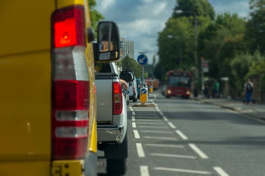 Cars and vans queueing in heavy traffic on a busy London road