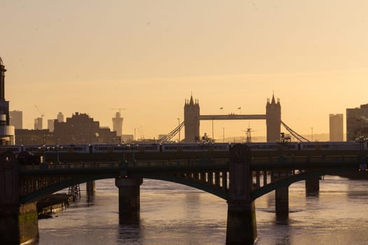 Southwark Bridge and Tower Bridge as viewed from the Millennium Bridge in the early morning haze