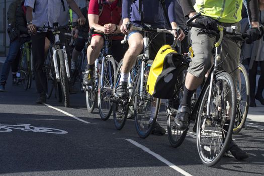 Cyclists, in a cycle lane, waiting at an road intersection in London, England