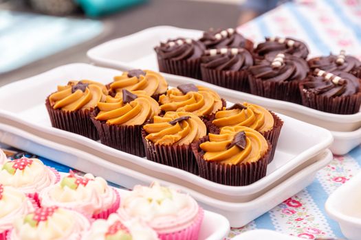 A variety of homemade cupcakes on a market stall