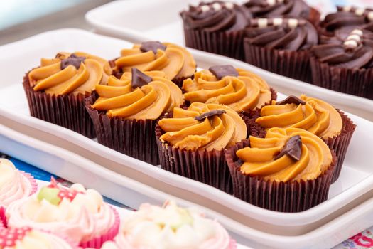 Homemade orange and chocolate cupcakes on a market stall