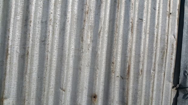 Silver corrugated metal sheet texture background. Steel metal cinc galvanized wave metal sheet for roof and walls.