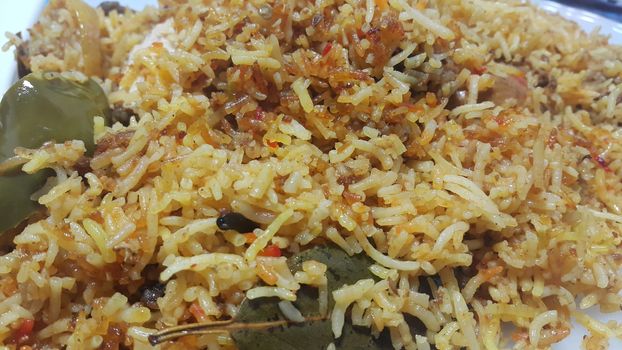 A close up  view of cooked rice chicken biryani made with traditional recipe popular for its delicious taste in Pakistan