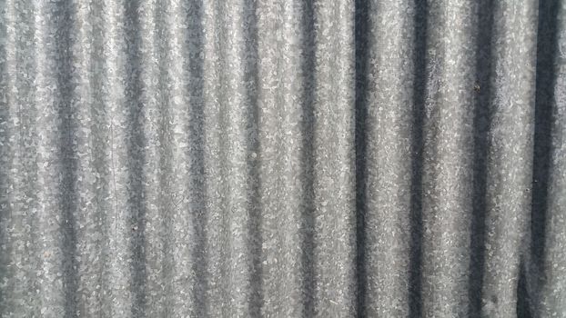 Silver corrugated metal sheet texture background. Steel metal cinc galvanized wave metal sheet for roof and walls.