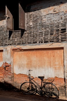 Aged street wall background, texture and bicycles