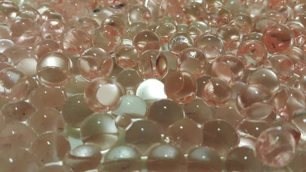 Closeup view with selective focus of shiny glittering orbeez or colorful water balls hydrogel. Water beads orbeez background.