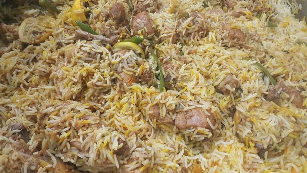 A close up  view of cooked rice chicken biryani made with traditional recipe popular for its delicious taste in Pakistan