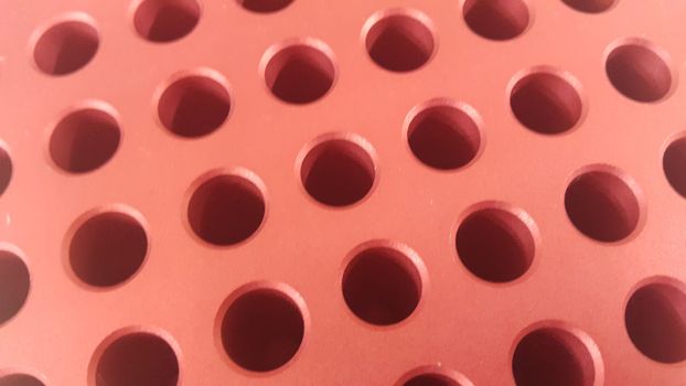 Close up view of holes in golden micro pipette box for scientific research laboratory: Science equipment