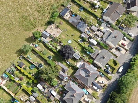 drone view of housing and countryside looking straight down showing houses and gardens and fields