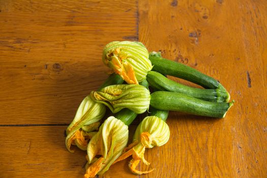 Arrangement of courgettes (zucchinis) on a wooden kitchen table