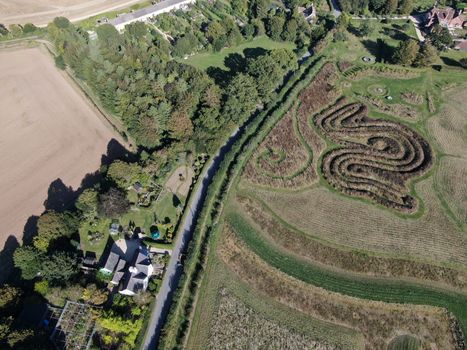 drone shot looking down on a created maze in a field 