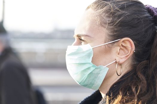 Close Up Of Young woman wearing face mask while walking in the streets of London