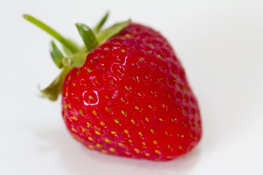 A single strawberry in a white background