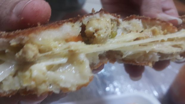 Closeup view of fried pizza bomb or pizza balls with dripping cheese. Pizza bombs are delicious and tasty altered form of pizza.