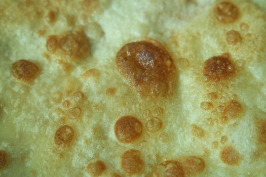 Closeup view of hand made plain bread in oil called paratha roti. Paratha is popular in India, Pakistan and other South Asian countries. Texture for bread.