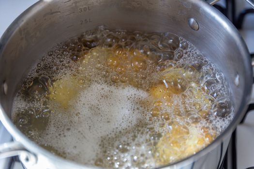 Pan of potatoes cooking in boiling water
