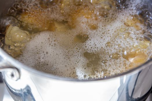 Pan of potatoes cooking in boiling water