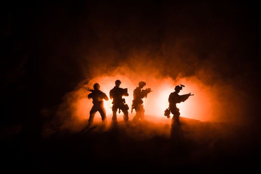 War Concept. Military silhouettes fighting scene on war fog sky background, World War Soldiers Silhouette Below Cloudy Skyline At night. Battle in ruined city. Selective focus