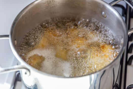 Pan of potatoes cooking in boiling water