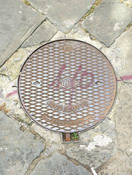 Manhole with graffiti in Pisa