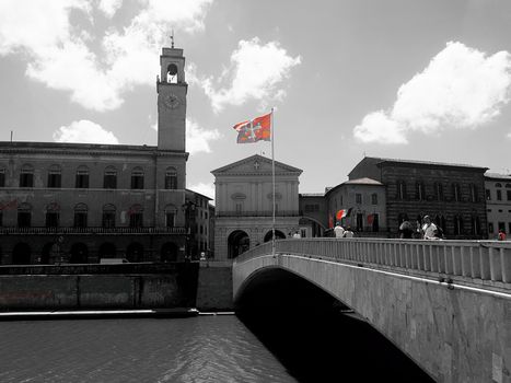 The red flag of Pisa in red on a black and white picture of the brdige called Ponte di Mezzo