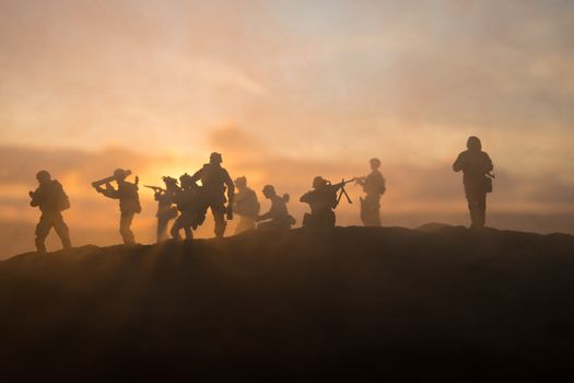 War Concept. Military silhouettes fighting scene on war fog sky background, World War Soldiers Silhouette Below Cloudy Skyline sunset. Selective focus