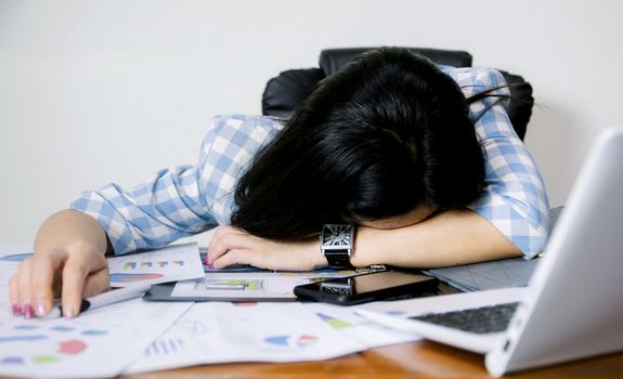 Women sleep on the office desk in the office.