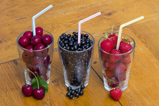 Three Glasses of Fruit on Wooden Table