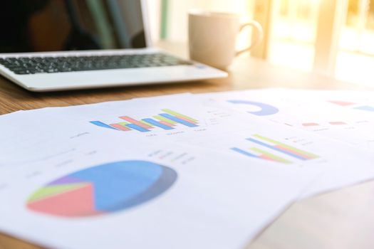 Graph on the desk analysis and laptop with business