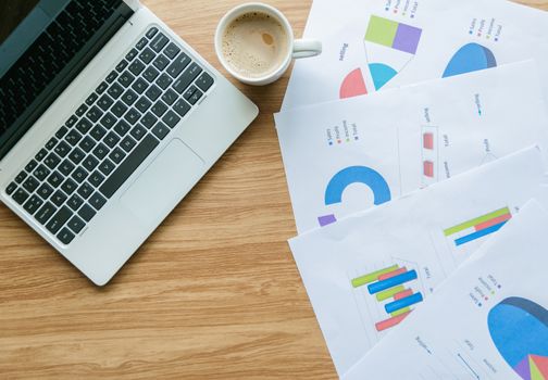 Graph on the desk analysis and laptop with business