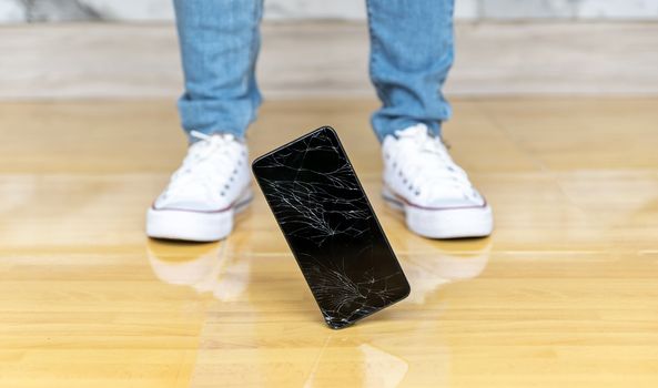 People fall smartphone on the floor broken screen