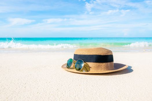 Hats and glasses placed on the beach and sea have a holiday summer relaxing and travel bright sky koh lipe thailand