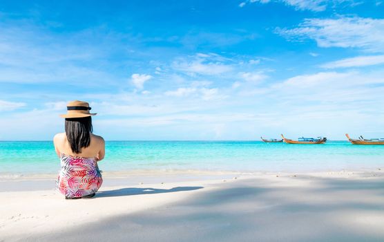 Women sitting back on the beach and sea have a holiday summer relaxing and travel bright sky koh lipe thailand