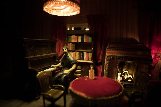 A realistic dollhouse living room with furniture and window at night. Man sitting at the old piano in dark room. Selective focus.