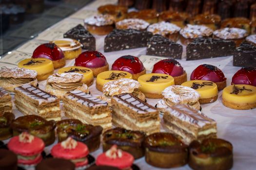 A variety of cakes on display at a market cake stall