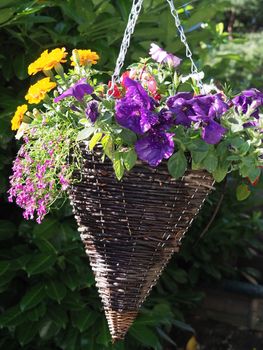 colourful hanging basket made of wicker hanging on a chain 